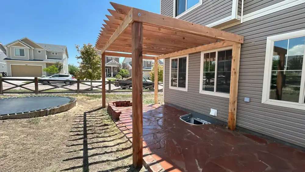 Outdoor kitchen and dining area arranged on a paved terrace